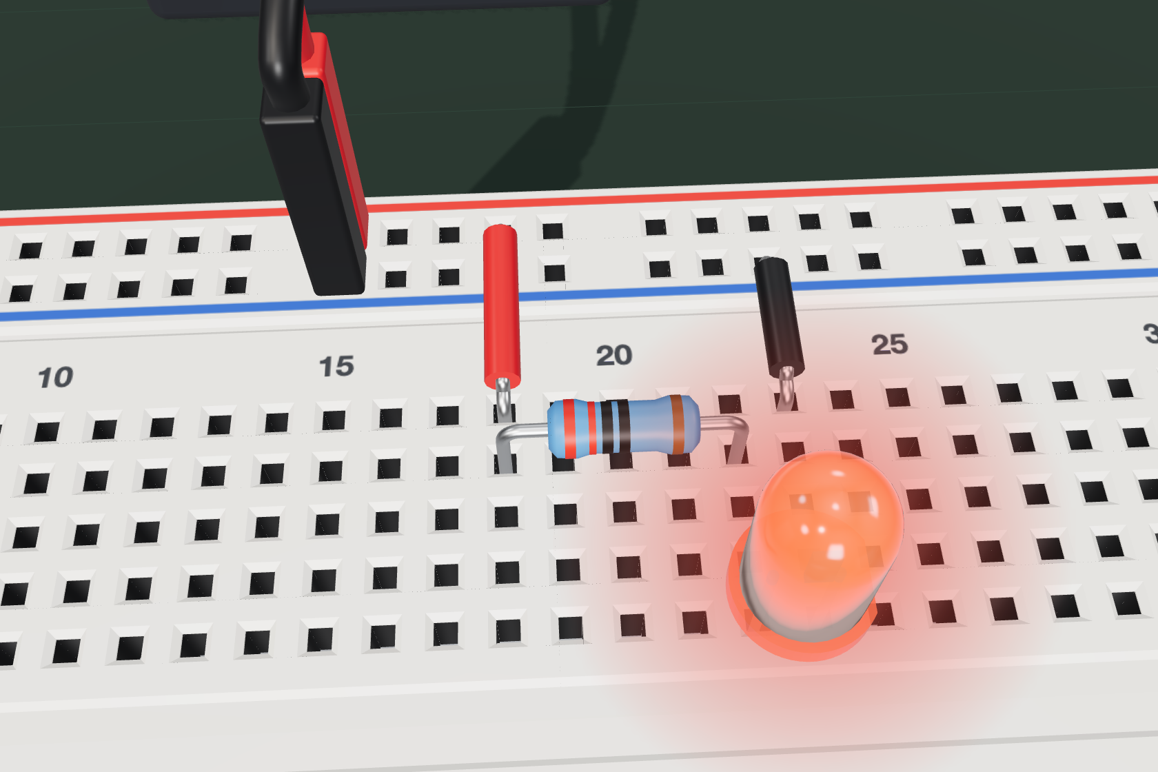 El primer circuito terminado: una fuente de 5 V, una resistencia y un LED rojo encendido